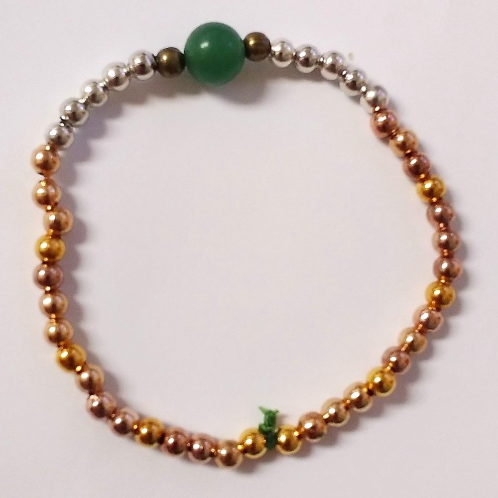 Gold, copper, silver, dark copper beads with a green stone homemade bracelet💚